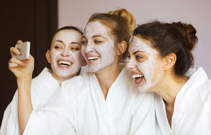 Women with spa masks smiling after their facial