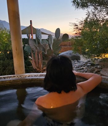 Woman in oasis tub at night