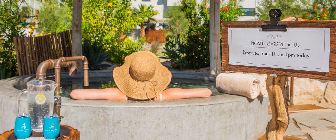 Woman soaking in private reserved oasis tub