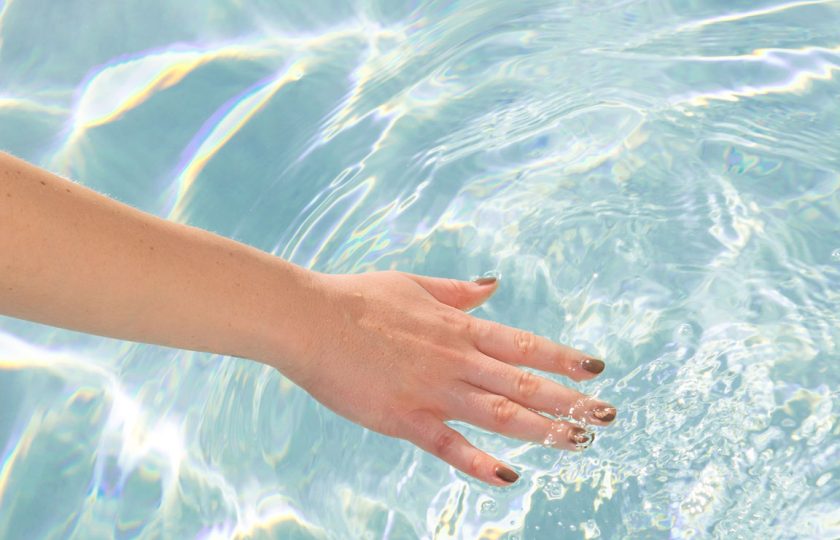 Woman's hand moving through water