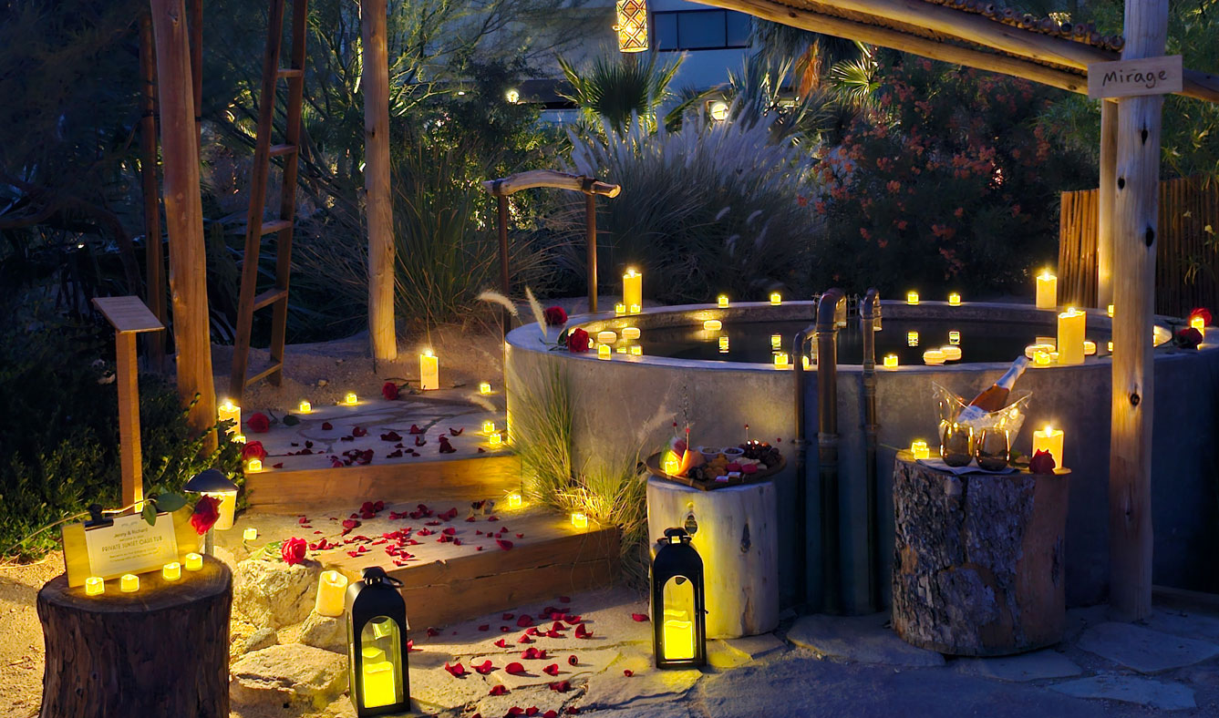 Romantic oasis tub surrounded by candles and rose petals