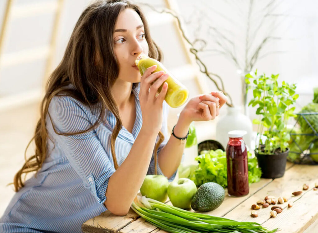 Woman drinking green juice, Cleansing with juice