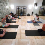 Yoga studio with 8 people practicing yoga